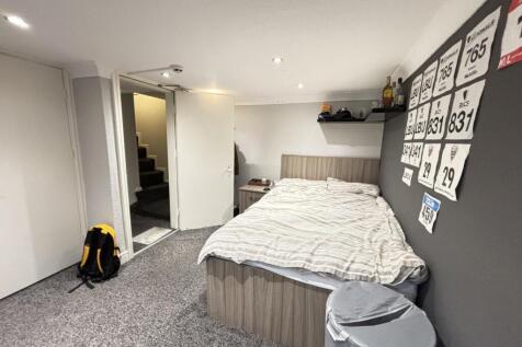 Spacious master bedroom with a comfortable doub...