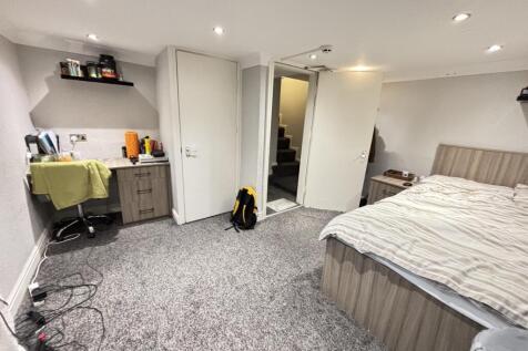 A well-maintained bedroom featuring a comfortab...