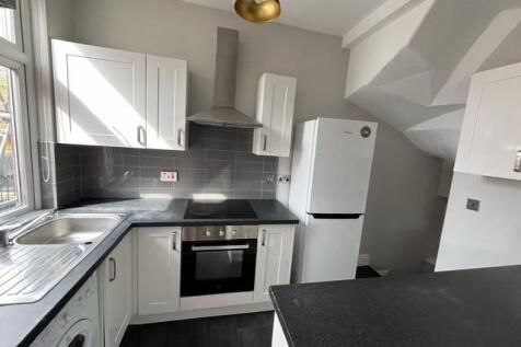 A modern, well-maintained kitchen featuring whi...