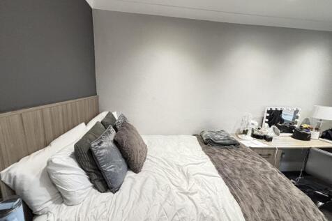 A well-maintained bedroom featuring a comfortab...