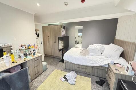 A spacious master bedroom featuring a large dou...