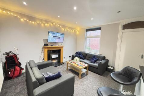 A spacious and well-lit contemporary living roo...