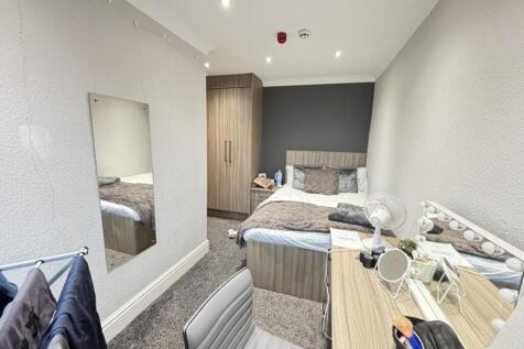 A well-maintained bedroom featuring a double be...