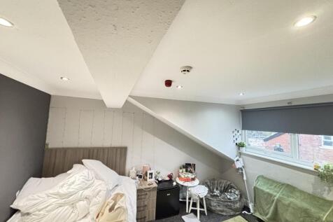 Bright and cozy bedroom with large windows allo...