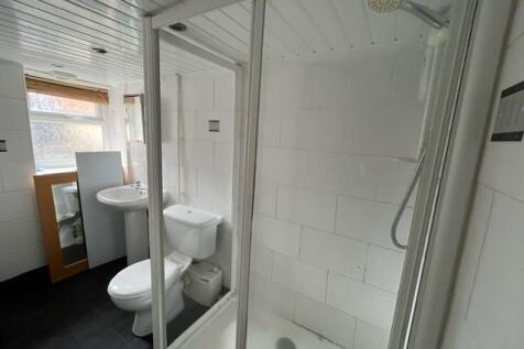 A clean and modern bathroom with a shower enclo...