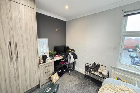 A cozy bedroom featuring a large window that al...