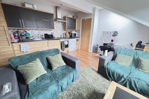 A modern, well-lit living room featuring comfor...