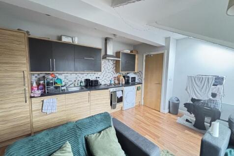 A modern, well-lit living room featuring a comf...