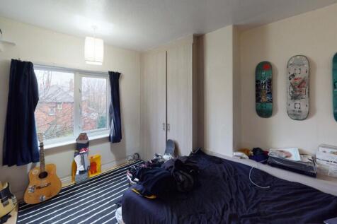 A cozy bedroom featuring a double bed, a large ...