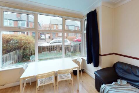 A bright and welcoming living room with large w...