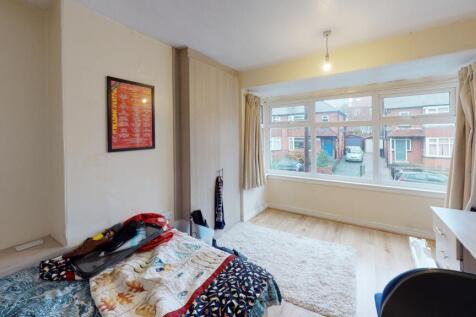 A bright and well-maintained bedroom featuring ...