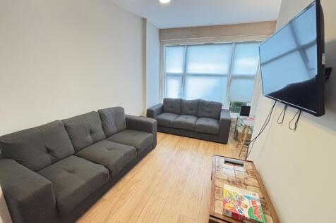 A modern, well-lit living room with two large, ...