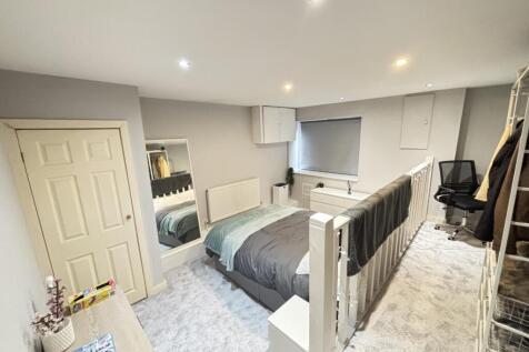 Bright and inviting bedroom featuring a comfort...