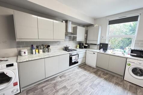 Bright and modern kitchen with ample natural li...