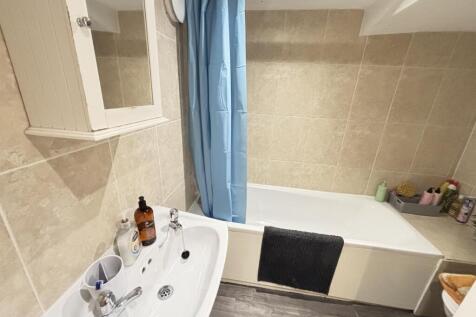 Bright and clean modern bathroom featuring a la...