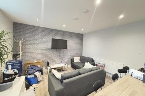 Spacious and well-lit modern living room featur...