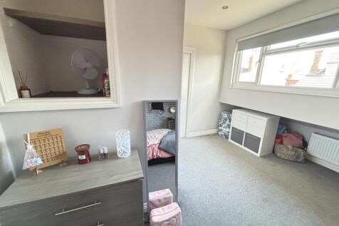 Bright and spacious living room with large wind...