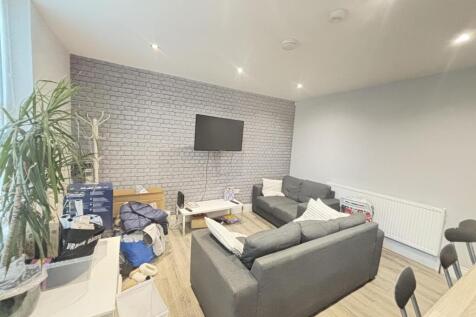 A spacious, modern living room with comfortable...