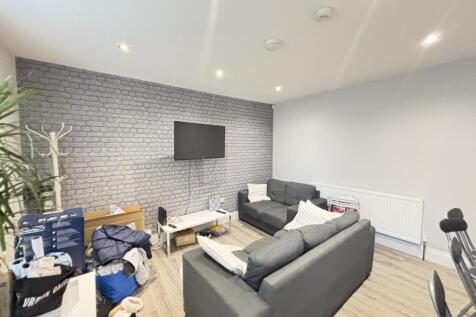 A modern, spacious living room featuring comfor...