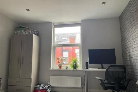 A modern and well-lit living room with a large ...