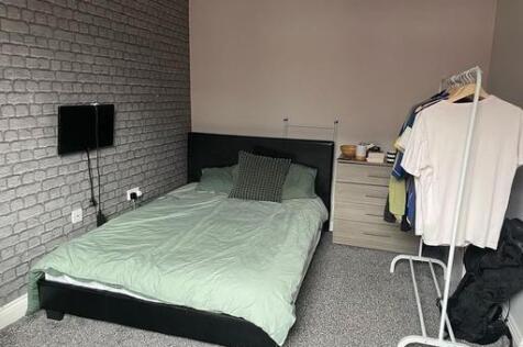 A well-maintained bedroom with a comfortable do...