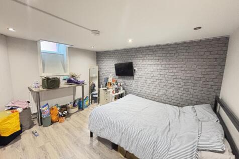 A well-maintained bedroom featuring a comfortab...