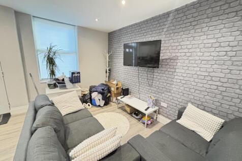 A modern living room featuring a large gray sof...