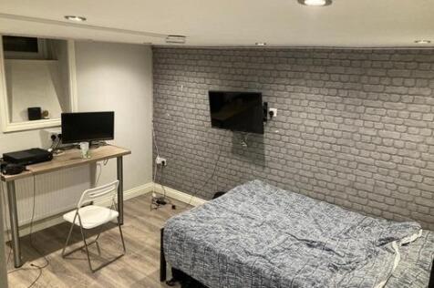 A modern bedroom featuring a comfortable double...