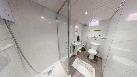 A clean and modern bathroom featuring a spaciou...