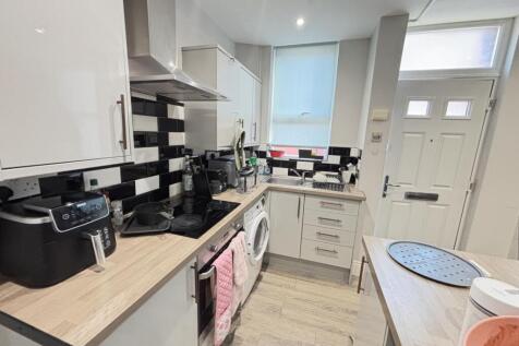 Bright and modern kitchen with ample storage, f...