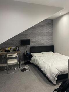A bright, modern double bedroom featuring a com...