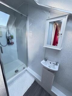 A bright and modern bathroom featuring a shower...