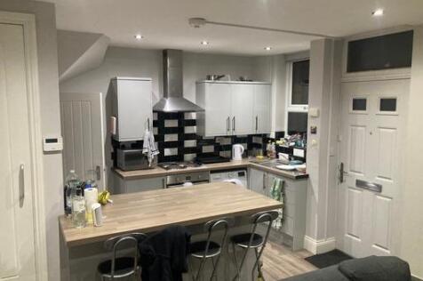 Modern kitchen with ample workspace, sleek whit...