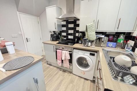 A well-maintained kitchen area featuring white ...