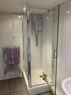 A modern, clean bathroom with a spacious shower...