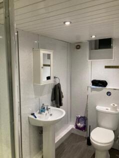 A clean and functional bathroom with a sink, to...