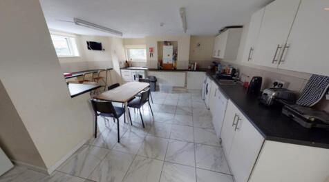 Modern kitchen featuring ample cabinetry and wo...