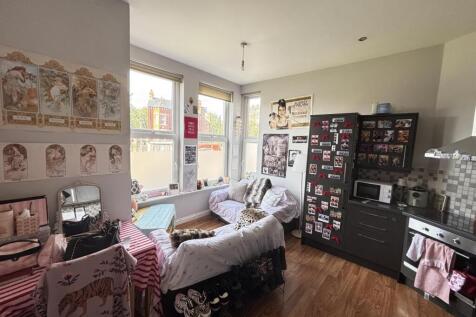 Bright and inviting living room with ample natu...