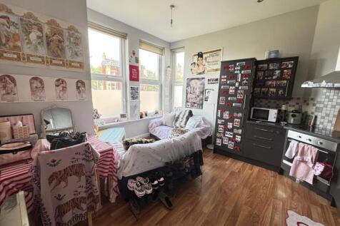 A cozy and well-lit living room featuring comfo...