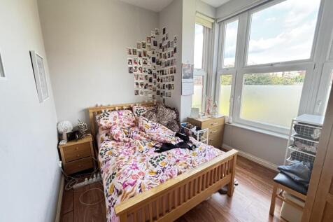 Bright and inviting bedroom with a comfortable ...
