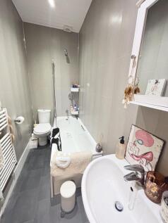 A well-maintained bathroom with a bathtub, toil...