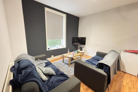 A modern and cozy living room with two sofas, a...