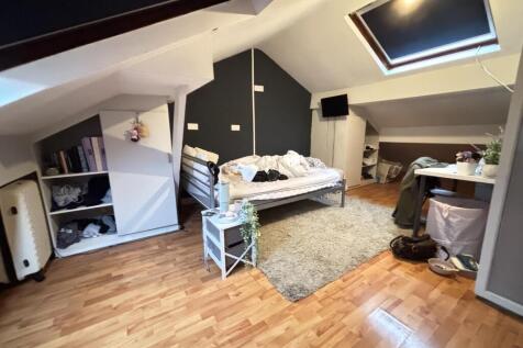 A cozy bedroom with a stylish bed frame, natura...