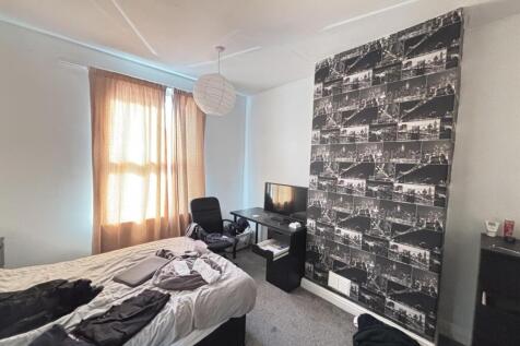 A well-lit, spacious living room featuring mode...