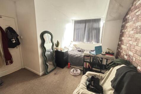 Cosy bedroom with soft carpeting, a comfortable...