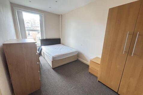 A well-maintained bedroom featuring a comfortab...