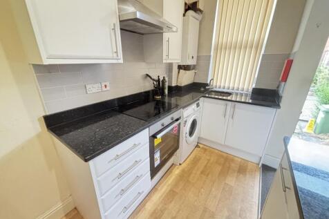 Bright and clean kitchen area with modern appli...