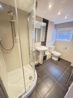 Modern and bright bathroom with a shower enclos...
