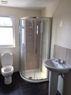 A clean and functional bathroom with a shower e...