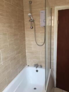 A clean, well-maintained bathroom with a bathtu...